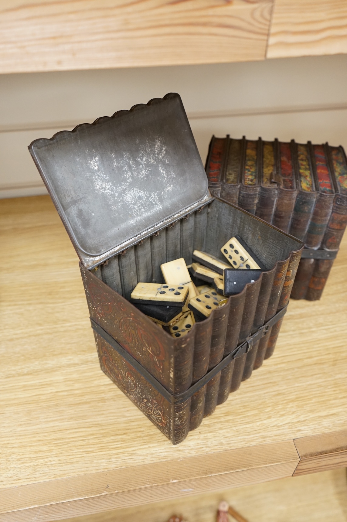 Two Huntley and Palmers novelty biscuit tins, each modelled as a set of books, 16cm